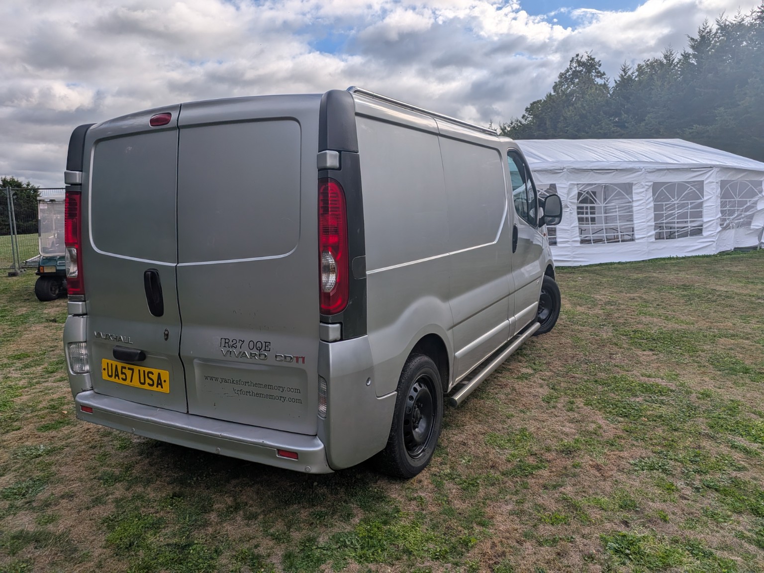 Silver Mooovit van parked beside a marquee